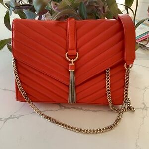Coral/orange leather quilted Marciano crossbody bag with gold tone hardware.